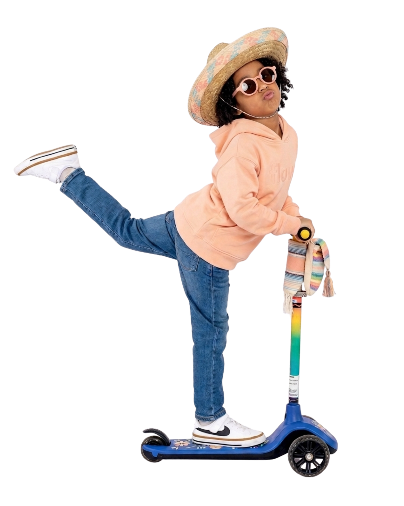 Child in peach with sunglasses and a scooter